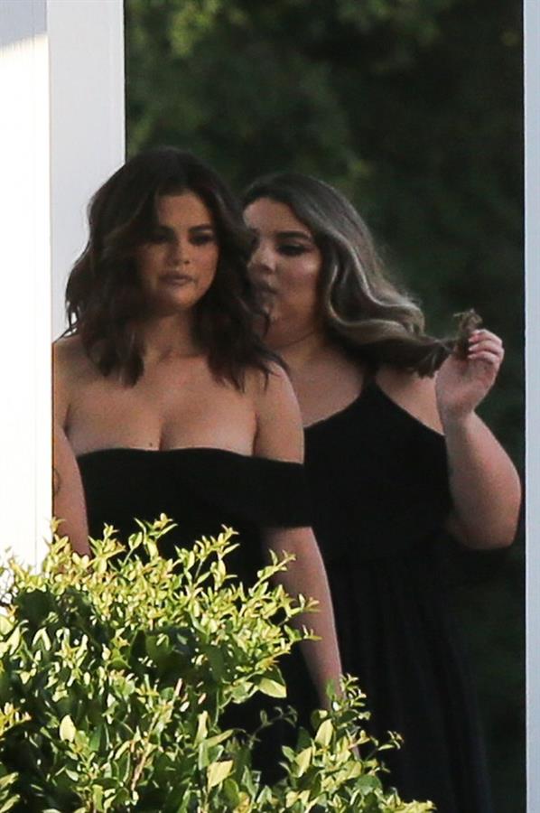 Selena Gomez sexy in a black dress for her cousins wedding showing nice cleavage seen by paparazzi.























