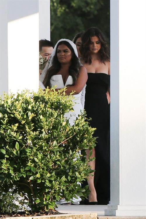Selena Gomez Pictures Selena Gomez sexy in a black dress for her cousins wedding showing nice cleavage seen by paparazzi.