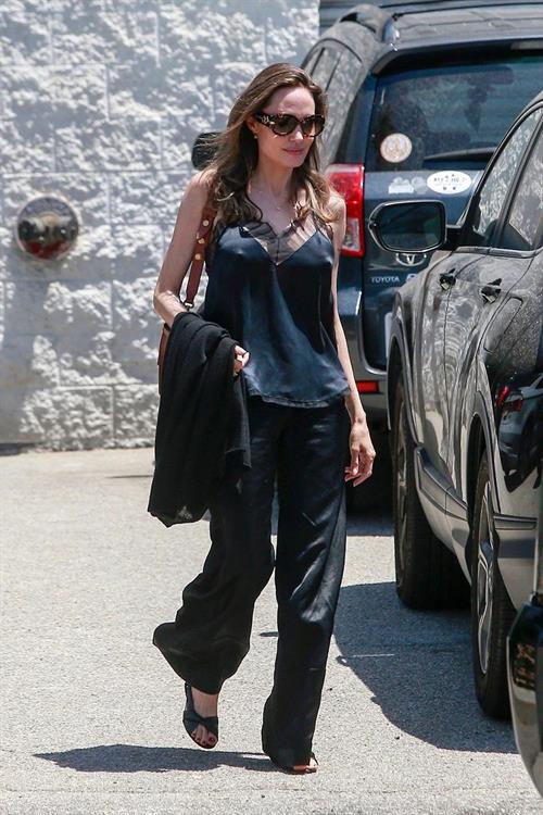 Angelina Jolie Pictures Angelina Jolie braless tits pokies in a black top seen by paparazzi showing her hard nipples.