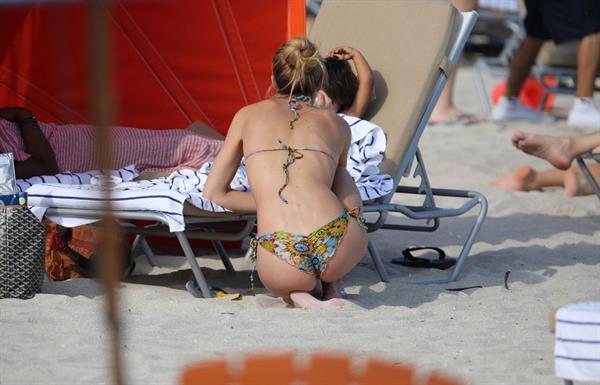 Doutzen Kroes bending over at the beach