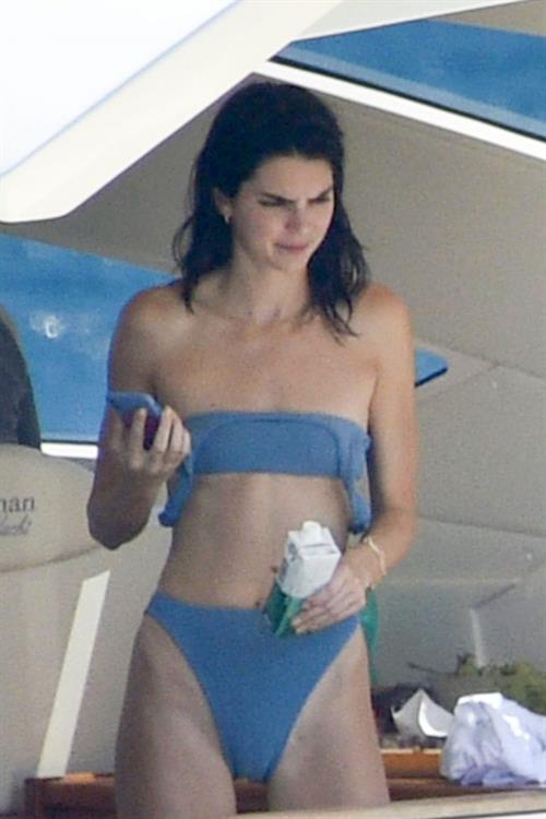 Kendall Jenner Bikini Pictures Kendall Jenner in a sexy bikini swimsuit on a yacht with Kourtney Kardashian seen by paparazzi.