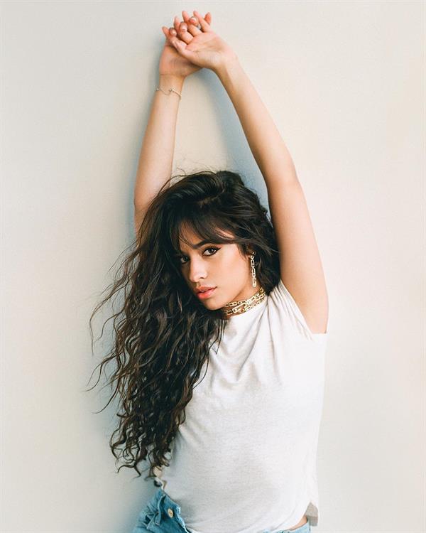 Camila Cabello braless boobs in a see through white top showing her tits.






