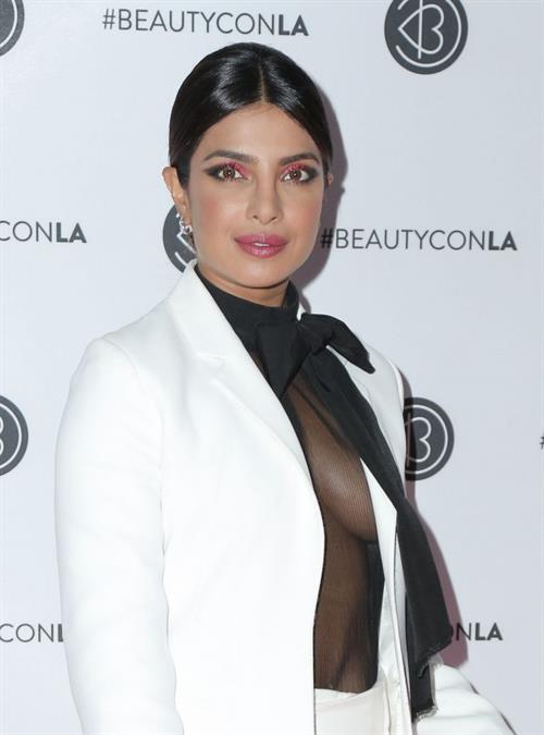 Priyanka Chopra Pictures Priyanka Chopra braless boobs in a see through top showing some nice cleavage at Beautycon.