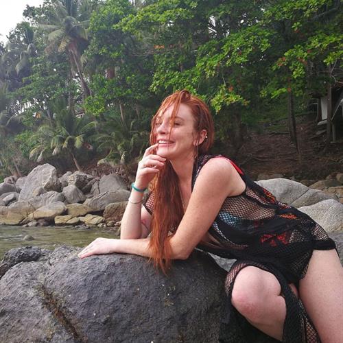 Lindsay Lohan side boob in a sexy fishnet outfit.
