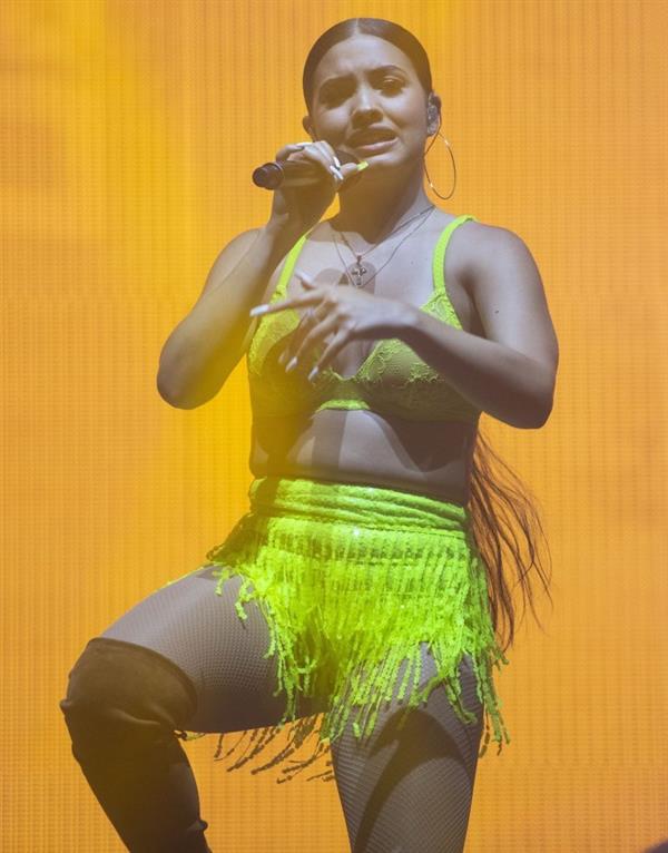 Mabel performing on stage singing in just a bra top showing off her boobs.
















