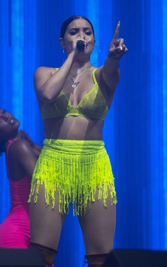 Mabel performing on stage singing in just a bra top showing off her boobs.
















