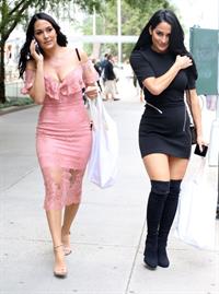 Nikki Bella braless boobs pokies in a black top showing off her tits seen by paparazzi with Brie Bella showing nice cleavage.










