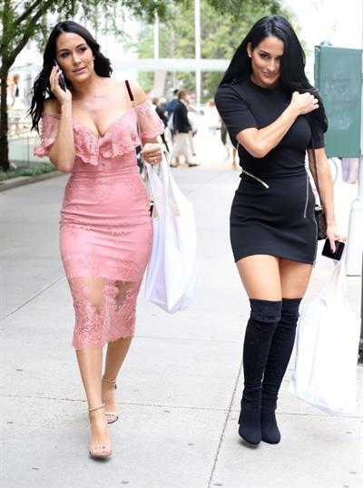 Nikki Bella braless boobs pokies in a black top showing off her tits seen by paparazzi with Brie Bella showing nice cleavage.










