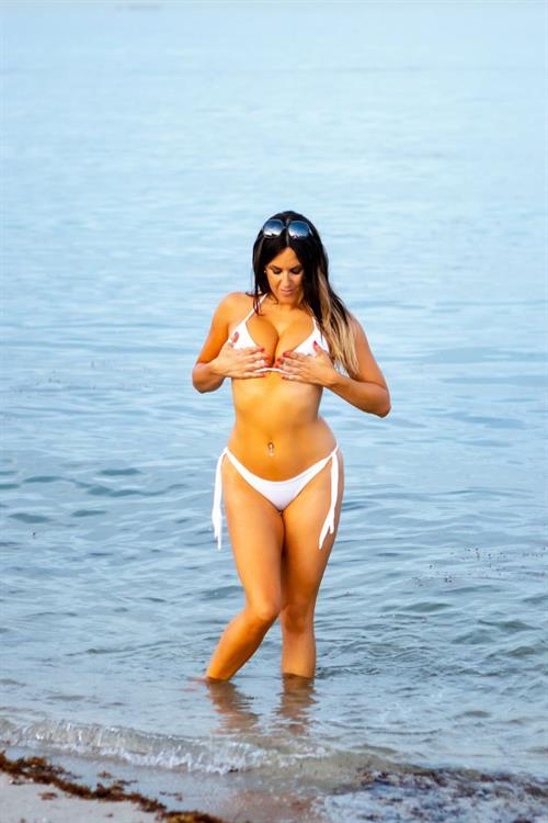 Claudia Romani Bikini Pictures Claudia Romani see ass in a thong bikini at the beach seen by paparazzi showing nice cleavage.