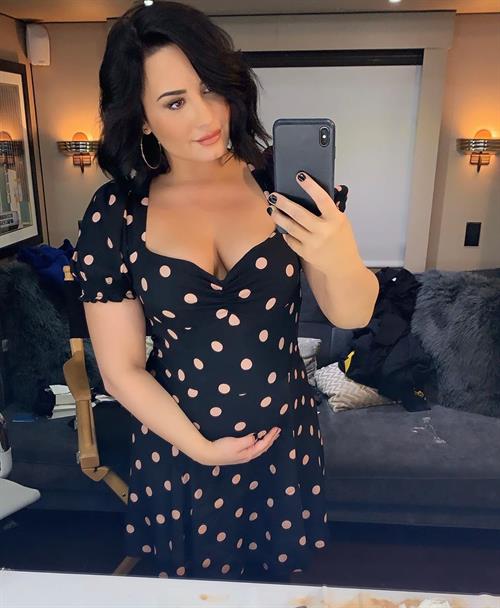 Demi Lovato Pictures Demi Lovato is playing a pregnant girl on Will and Grace looks pretty real she's also showing nice cleavage with her big boobs.