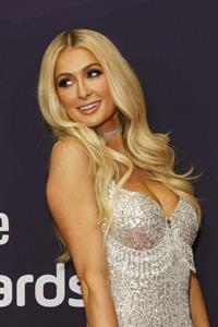 Paris Hilton in a sexy little minidress showing nice cleavage photographed on the red carpet at the Streamy Awards.
