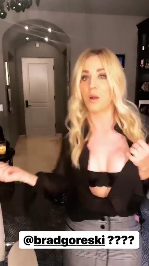 Kaley Cuoco flashing her big boobs cleavage in an open black top.