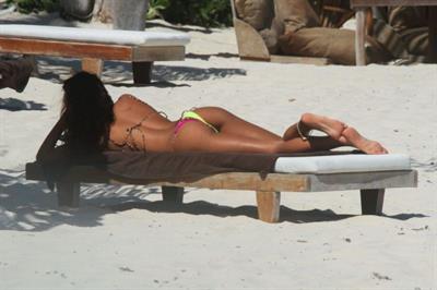 Thaila Ayala sexy ass in a thong bikini also showing nice cleavage seen by paparazzi on the beach in Mexico.