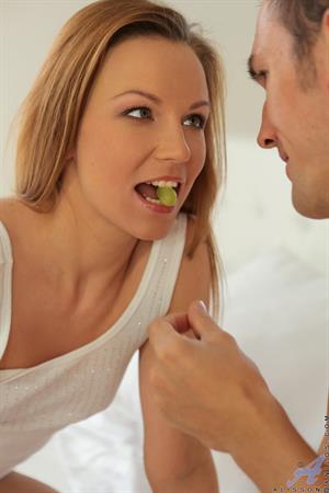 All natural redhead Alisson is enjoying a morning in bed with her man. The fiery babe lets her beau suck on her small tits, then rewards him with a lingering blowjob and takes advantage of his position to climb aboard and take him deep in her landing strip pussy cowgirl style. After a wild ride, Alisson finally reaches her climax and then helps her man to cum all over her flat tanned belly to complete their raunchy fuck fest.