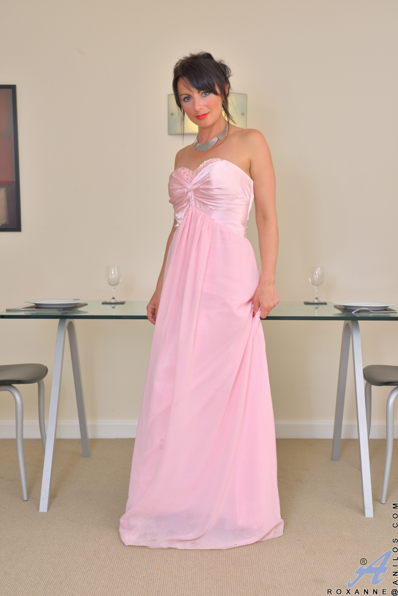 Sexy milf Roxanne has just returned from an evening show, and now the horny housewife needs to let off some steam! She slips out of her evening gown and slips a hand down her panties to discover that her landing strip twat is dripping and eager for her to get naked and use her fingers to rock her world.