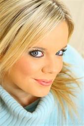  Beautiful blonde secretary slips out of her blue jumper and black skirt to reveal her sexy pink lingerie. 