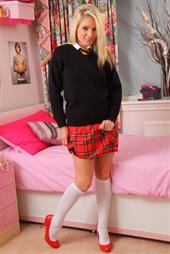  Curvy blonde looks sensational as she strips out of her red tartan minskirt and red high heels. 