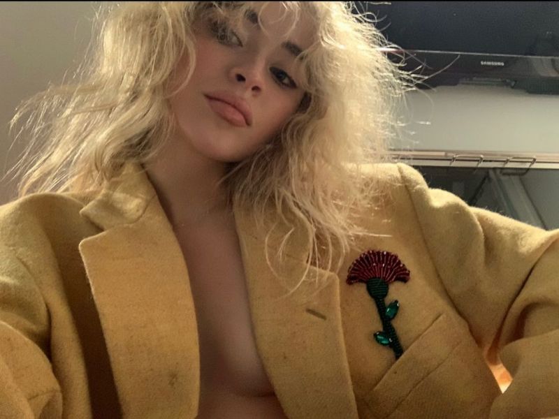 Sabrina Carpenter Pictures Sabrina Carpenter braless boobs in an open jacket top showing off her big tits cleavage.
