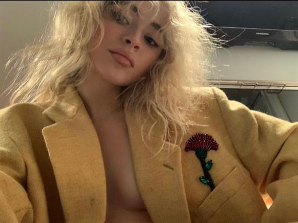 Sabrina Carpenter braless boobs in an open jacket top showing off her big tits cleavage.