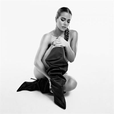 Khloe Kardashian goes nude to promote and sell shoes posing fully naked wearing just boots in a new ad campaign.