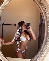 Alisha Sahi in a bikini taking a selfie