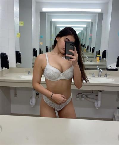 Alisha Sahi in lingerie taking a selfie