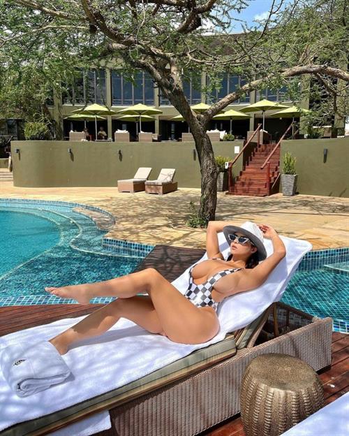 Demi Rose boobs showing nice cleavage with her big tits in a low cut revealing swimsuit on vacation.