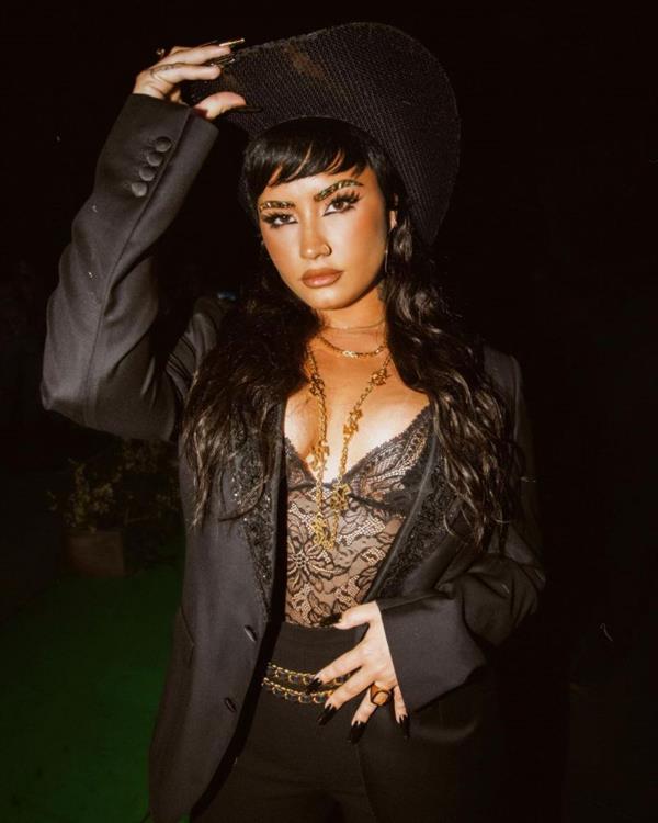 Demi Lovato boobs showing nice cleavage with her big tits in a sexy see through black lingerie top.