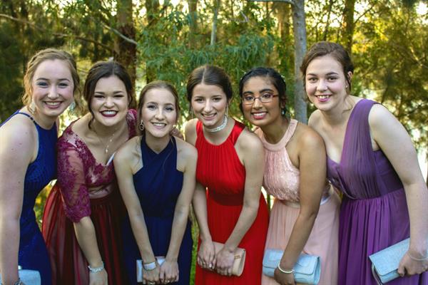 Caitlin Gooch in a red dress (4th from left) with friends