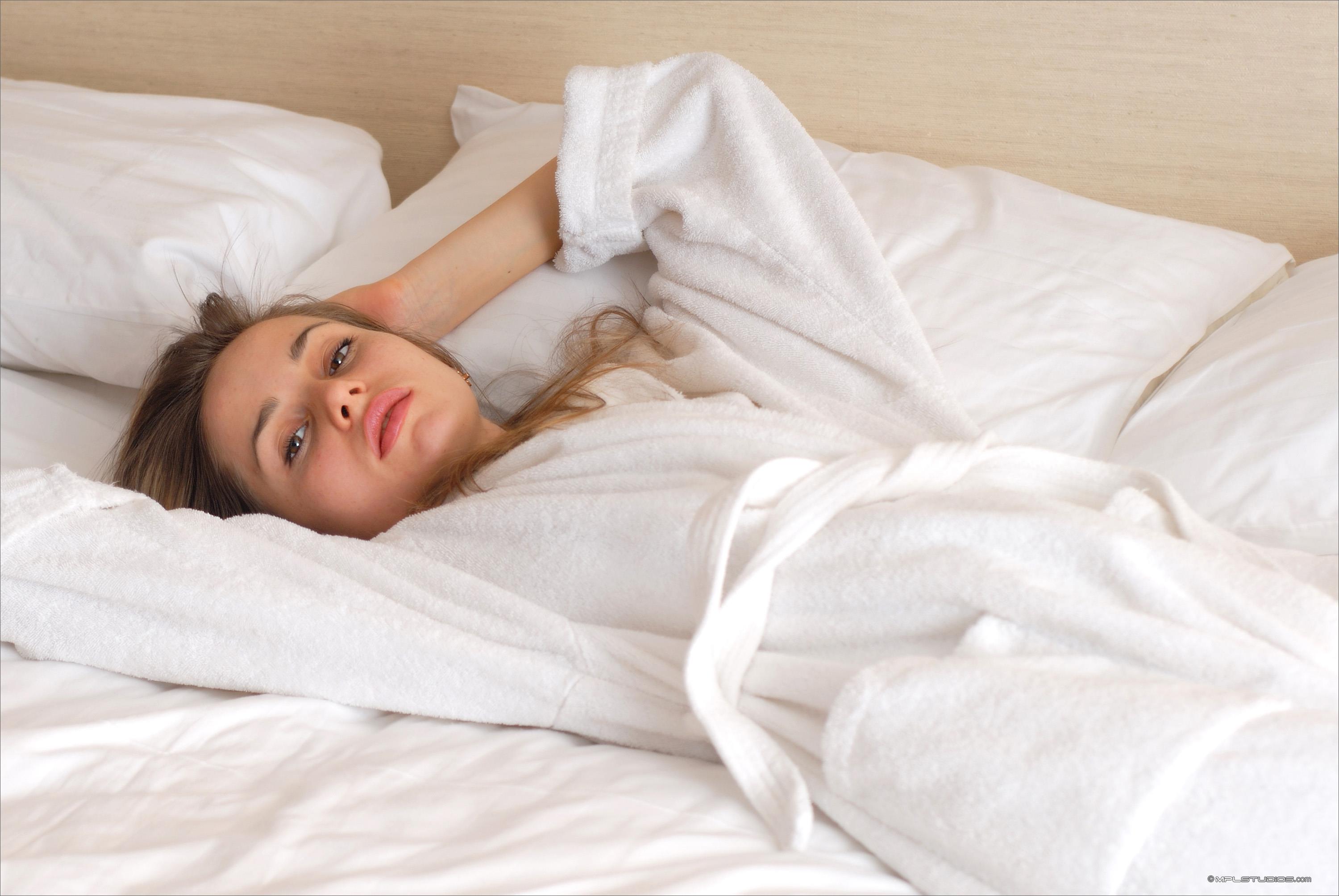 Anya posing on a bed
