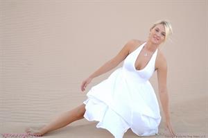 Alison Angel poses in her sexy white dress