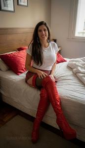 Pornstar Queen Eugenia in incredible red thigh-high boots and lingerie.