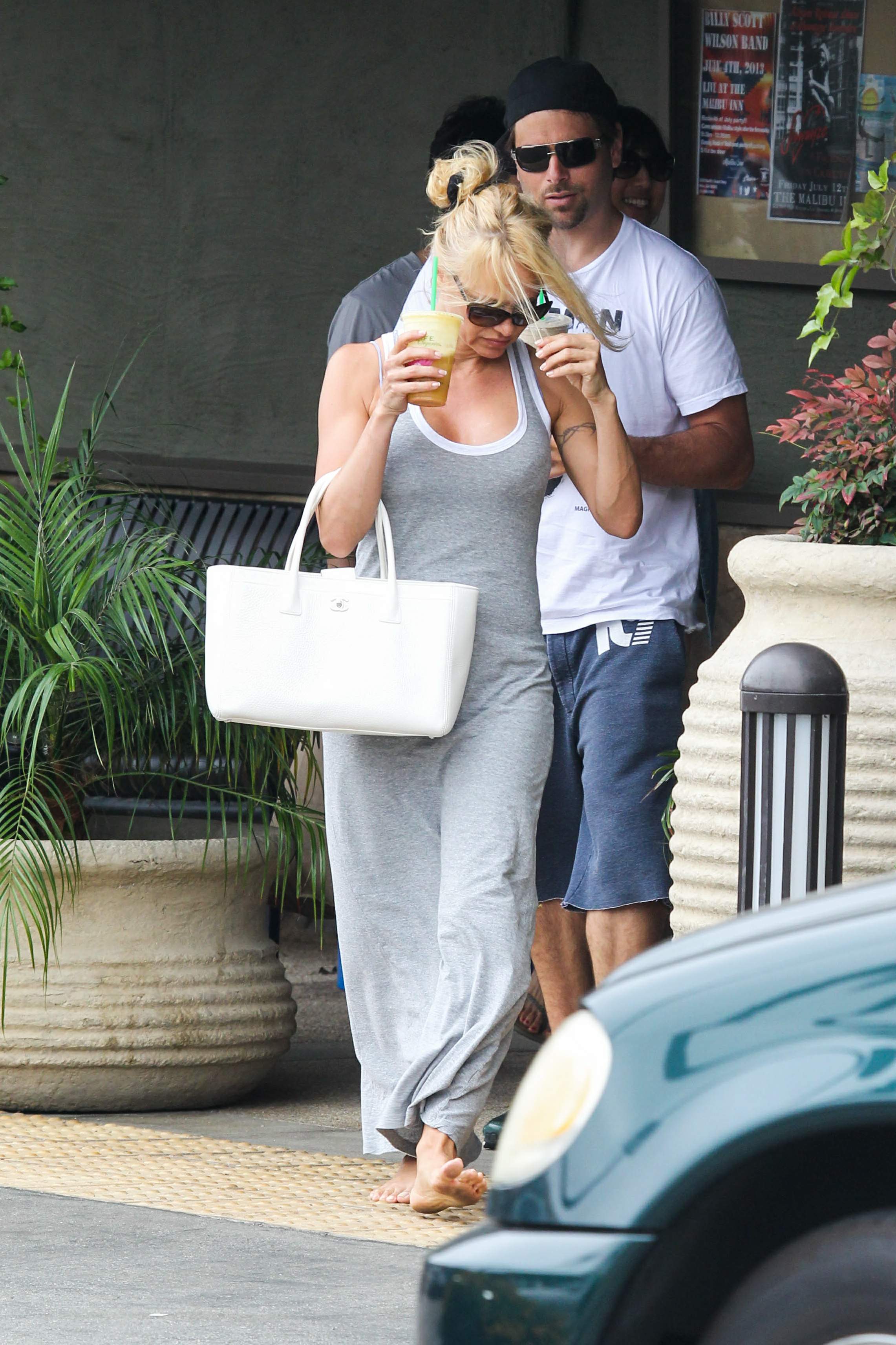 Pamela Anderson leaves barefoot a local Restaurant with a friend in Malibu July 6, 2013 